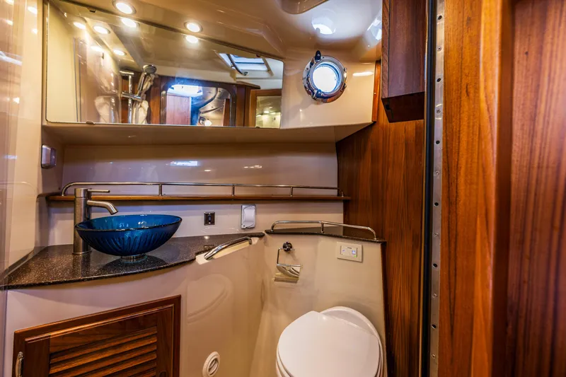 Salty Bliss Yacht Photos Pics Luxurious bathroom in 2021 Ranger Tugs R-31 CB with modern fixtures and elegant wood accents.