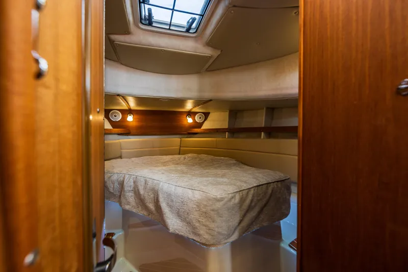 Salty Bliss Yacht Photos Pics 2021 Ranger Tugs R-31 CB cabin interior with cozy bed and ambient lighting.