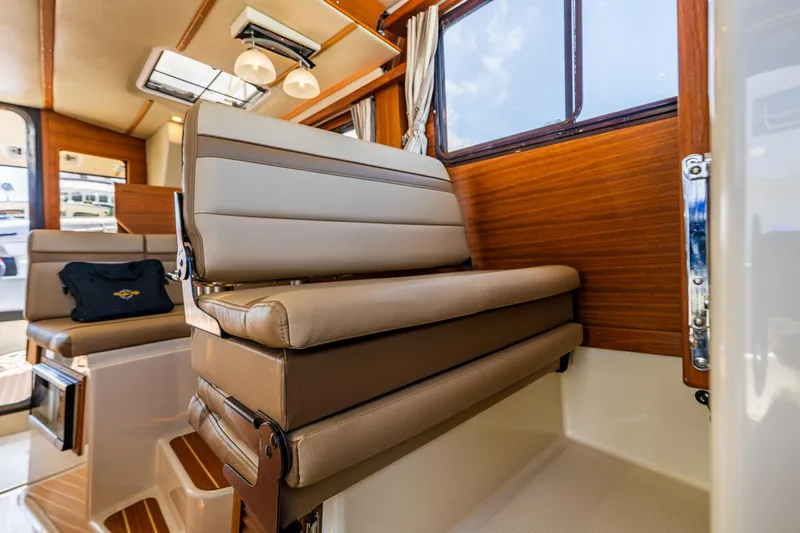 Salty Bliss Yacht Photos Pics Interior of 2021 Ranger Tugs R-31 CB, featuring elegant seating and wood paneling.