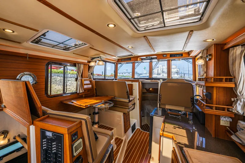 Salty Bliss Yacht Photos Pics Interior of 2021 Ranger Tugs R-31 CB boat, featuring wood accents and spacious seating.