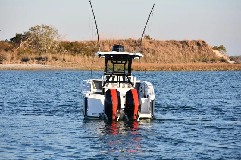  Yacht Photos Pics 2022 Blackfin 272 CC boat on water, dual engines, coastal background.
