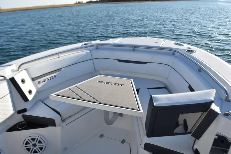  Yacht Photos Pics 2022 Blackfin 272 CC boat interior with seating and table on calm water.