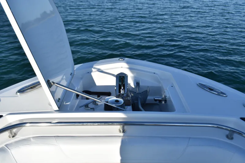  Yacht Photos Pics 2022 Blackfin 272 CC boat anchor compartment open on calm water.