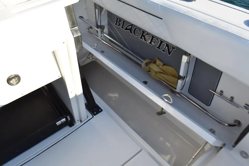 Yacht Photos Pics 2022 Blackfin 272 CC boat interior storage compartment with logo and equipment.