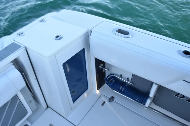  Yacht Photos Pics 2022 Blackfin 272 CC boat deck with storage and coiled hose.