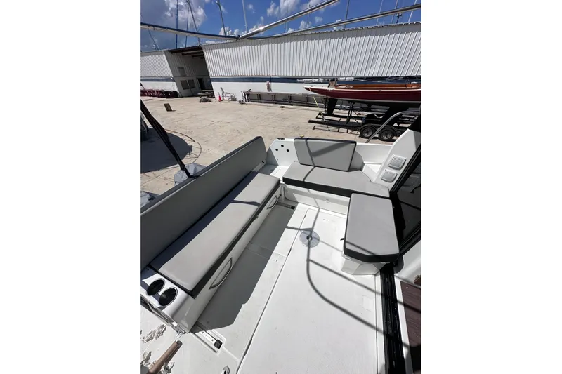 Pawsitive Attitude Yacht Photos Pics 2019 Jeanneau 895 boat interior with cushioned seating and cup holders.