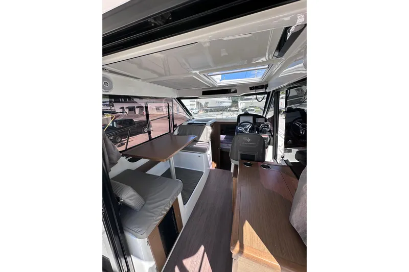 Pawsitive Attitude Yacht Photos Pics Interior of 2019 Jeanneau 895 boat, featuring seating and helm station.
