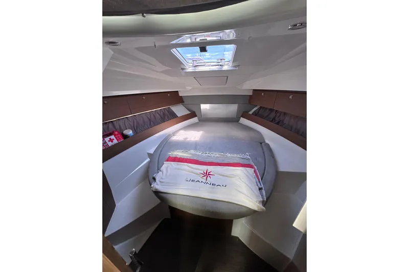 Pawsitive Attitude Yacht Photos Pics Cozy cabin interior of 2019 Jeanneau 895 boat with skylight and bedding.