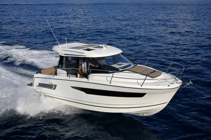 Pawsitive Attitude Yacht Photos Pics 2019 Jeanneau 895NC motorboat cruising on open water.