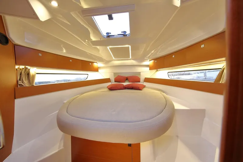 Pawsitive Attitude Yacht Photos Pics 2019 Jeanneau 895NC cabin interior with cozy bed and modern lighting.