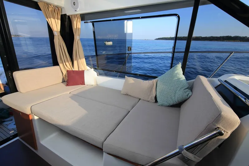 Pawsitive Attitude Yacht Photos Pics Interior of 2019 Jeanneau 895NC yacht with cozy seating and ocean view.