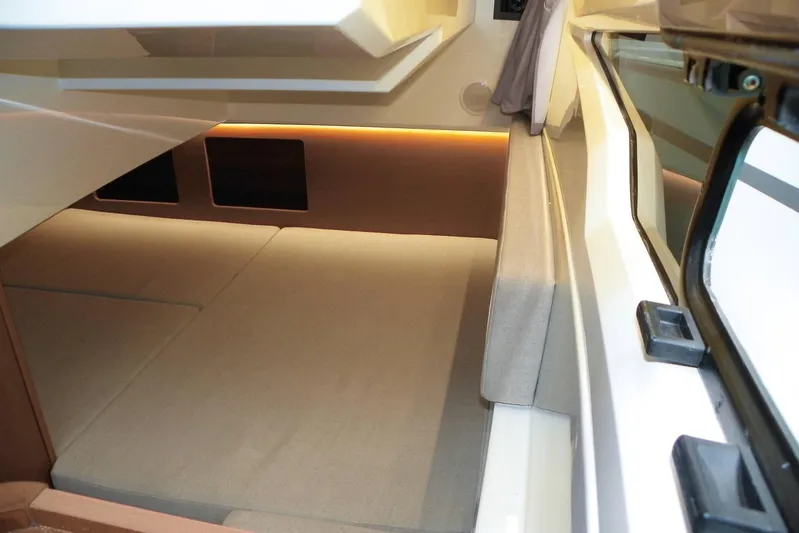 Pawsitive Attitude Yacht Photos Pics Interior cabin of 2019 Jeanneau 895NC boat with cozy seating and ambient lighting.