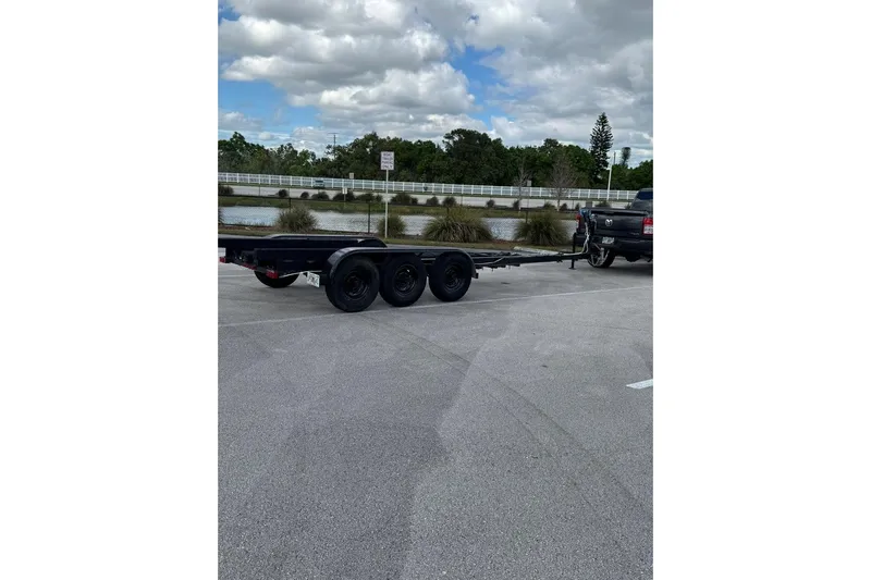 Pawsitive Attitude Yacht Photos Pics Trailer for Jeanneau 895NC 2019 boat, parked in a lot with cloudy sky.