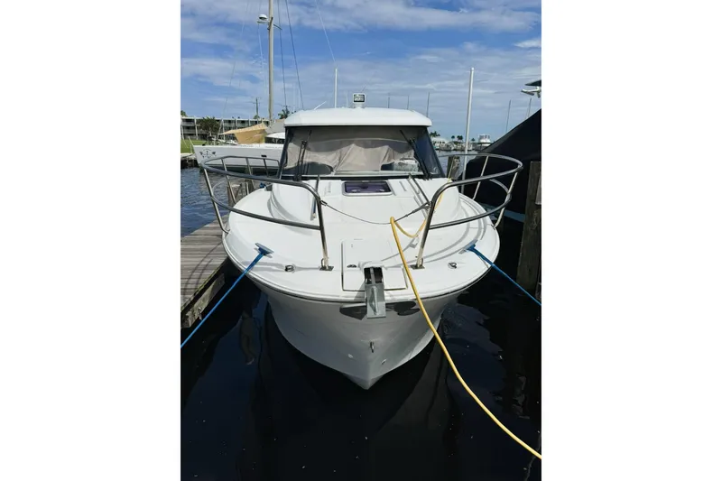 Pawsitive Attitude Yacht Photos Pics 2019 Jeanneau 895NC boat docked at marina under clear blue sky.