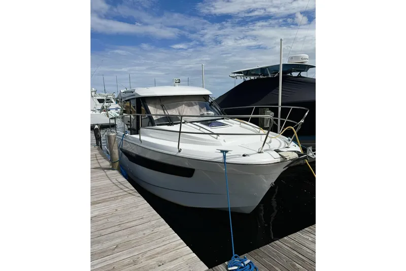 Pawsitive Attitude Yacht Photos Pics 2019 Jeanneau 895NC boat docked at marina under blue sky.