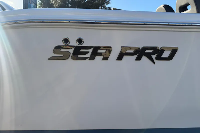  Yacht Photos Pics 2026 Sea Pro 292 DLX boat logo on white hull, sunlight reflecting.