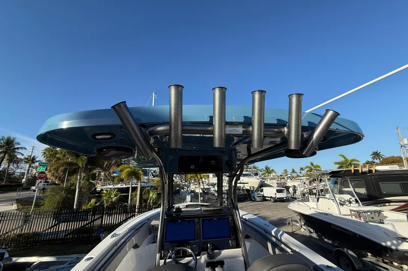  Yacht Photos Pics 2026 Sea Pro 292 DLX boat with rod holders, docked under clear blue sky.