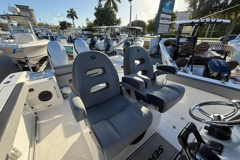  Yacht Photos Pics 2026 Sea Pro 292 DLX boat interior with dual captain chairs and steering wheel.