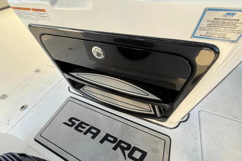  Yacht Photos Pics 2026 Sea Pro 292 DLX boat interior with storage compartment and yacht certification label.