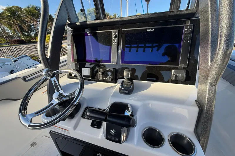  Yacht Photos Pics 2026 Sea Pro 292 DLX boat dashboard with steering wheel and dual Simrad displays.