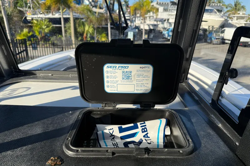  Yacht Photos Pics 2026 Sea Pro 292 DLX boat dashboard with open storage compartment and instruction label.
