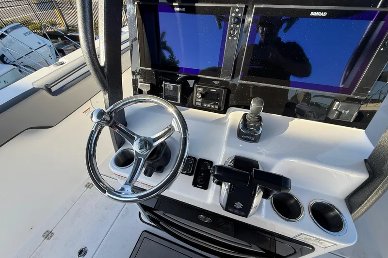  Yacht Photos Pics 2026 Sea Pro 292 DLX boat dashboard with steering wheel and dual Simrad displays.