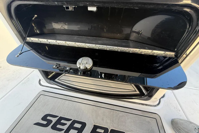  Yacht Photos Pics Open storage compartment on 2026 Sea Pro 292 DLX boat, showcasing sleek design and functionality.