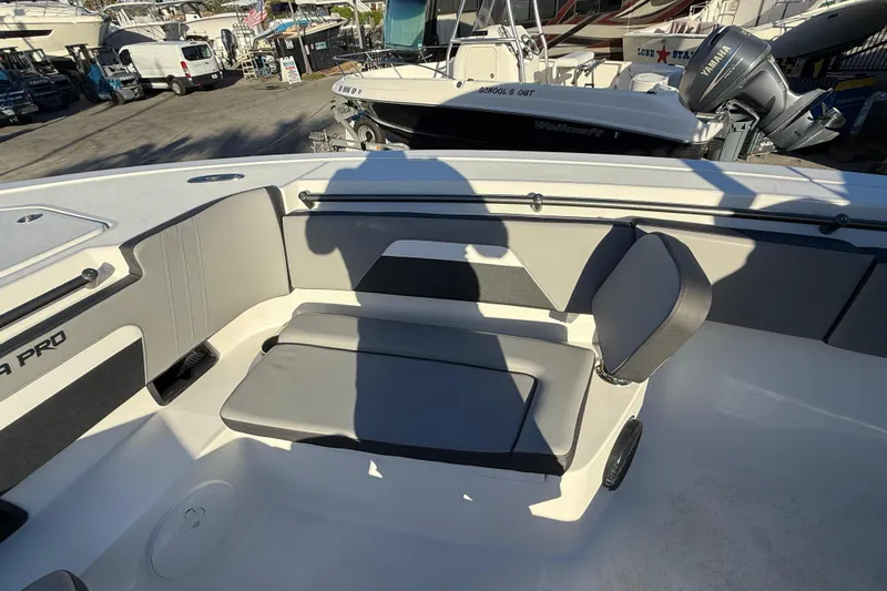  Yacht Photos Pics 2026 Sea Pro 292 DLX boat interior with cushioned seating and shadow.