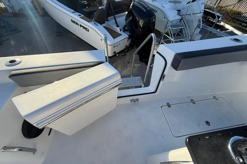  Yacht Photos Pics 2026 Sea Pro 292 DLX boat interior with seating and access ladder.