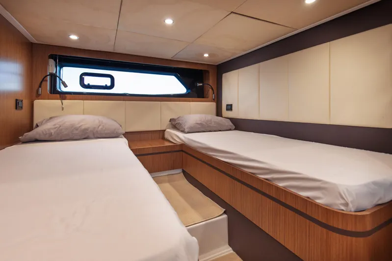  Yacht Photos Pics Twin cabin interior of 2016 Azimut Atlantis 43 yacht, featuring modern design and cozy bedding.