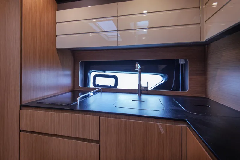  Yacht Photos Pics Modern kitchen interior of 2016 Azimut Atlantis 43 yacht with sleek wood cabinetry.