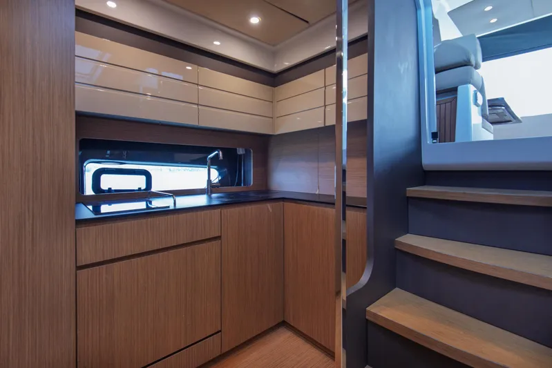  Yacht Photos Pics Interior of 2016 Azimut Atlantis 43 yacht, featuring modern kitchen and wooden cabinetry.