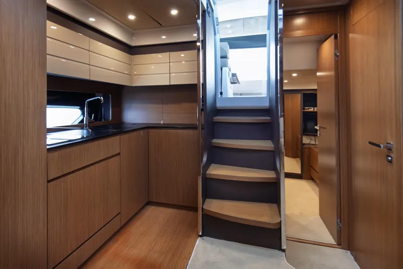  Yacht Photos Pics Interior of 2016 Azimut Atlantis 43 yacht, featuring modern kitchen and wooden staircase.