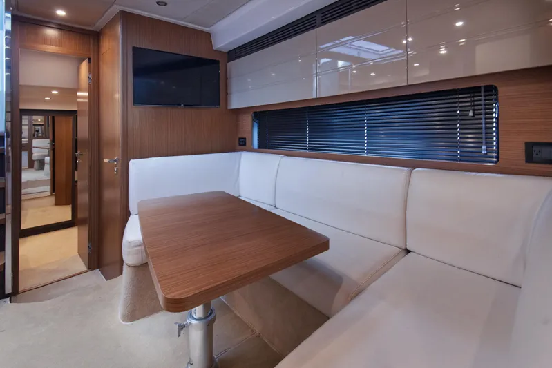  Yacht Photos Pics Luxurious interior of 2016 Azimut Atlantis 43 yacht with sleek wood and white seating.