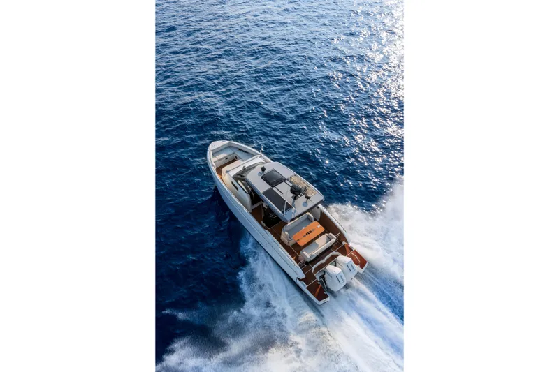  Yacht Photos Pics 2026 Beneteau Gran Turismo 35 cruising on open blue sea, aerial view.