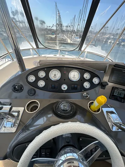 Euphoria Yacht Photos Pics 2003 Riviera 37 Flybridge helm with gauges and marina view.