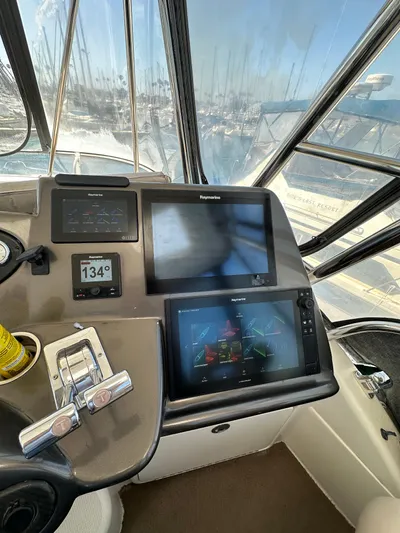 Euphoria Yacht Photos Pics Control panel of 2003 Riviera 37 Flybridge with navigation screens and throttle controls.
