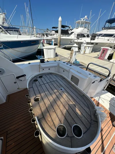 Euphoria Yacht Photos Pics 2003 Riviera 37 Flybridge yacht with wooden deck at marina.