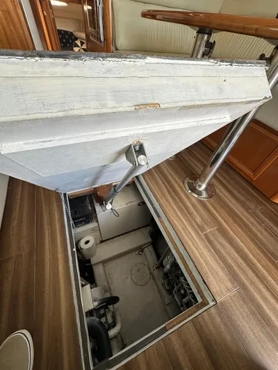 Euphoria Yacht Photos Pics Engine room access hatch on 2003 Riviera 37 Flybridge yacht, wooden flooring, metal railing.