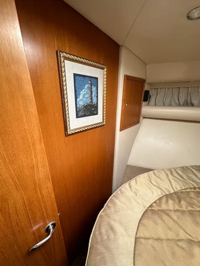 Euphoria Yacht Photos Pics Interior of 2003 Riviera 37 Flybridge with wood paneling and framed artwork.