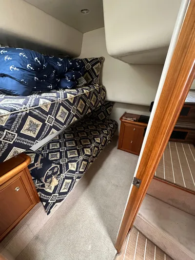 Euphoria Yacht Photos Pics Interior of 2003 Riviera 37 Flybridge with bunk beds and nautical-themed bedding.