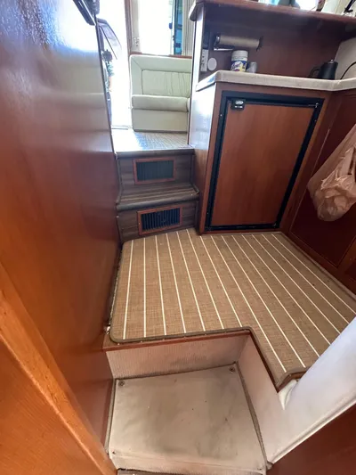 Euphoria Yacht Photos Pics Interior of 2003 Riviera 37 Flybridge yacht with wooden cabinetry and compact kitchen area.