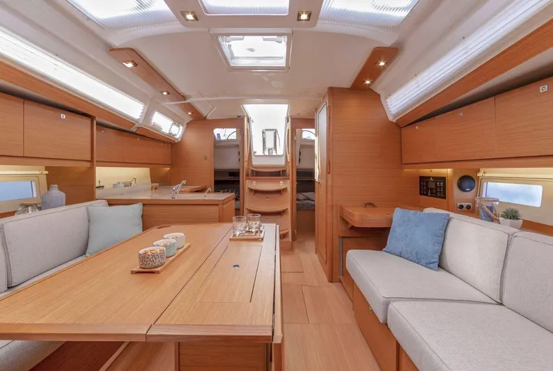  Yacht Photos Pics Luxurious interior of 2022 Dufour 390 Grand Prix sailboat, featuring elegant wood finishes and modern design.