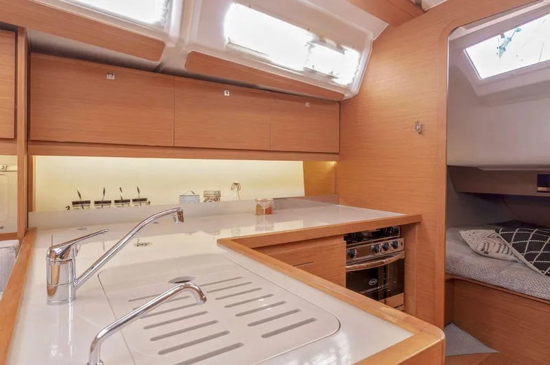  Yacht Photos Pics Modern kitchen interior of 2022 Dufour 390 Grand Prix sailboat, featuring sleek design and amenities.