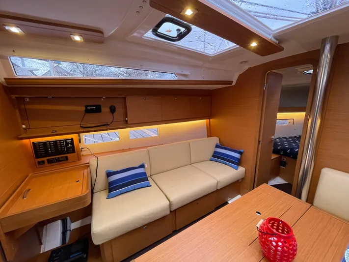  Yacht Photos Pics Interior of 2022 Dufour 390 Grand Prix sailboat with cozy seating and modern design.