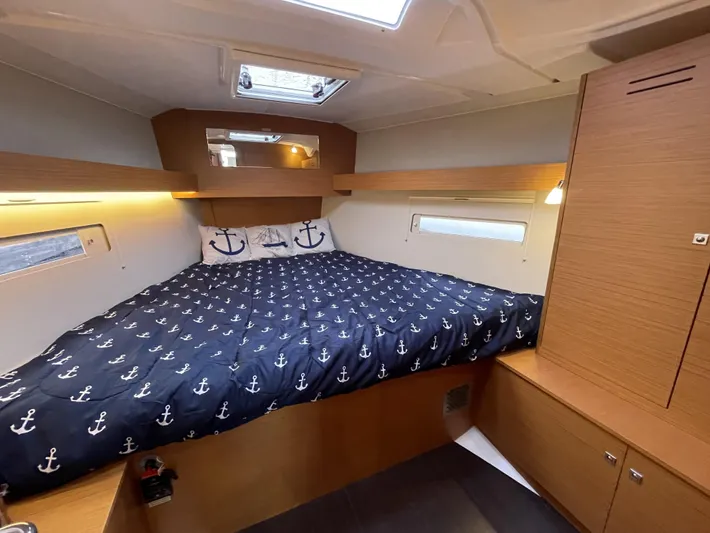  Yacht Photos Pics Luxurious cabin interior of 2022 Dufour 390 Grand Prix sailboat with anchor-themed bedding.