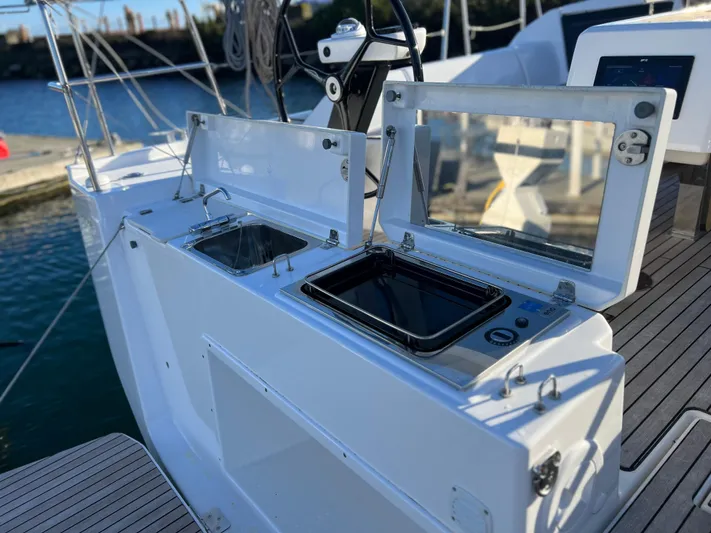  Yacht Photos Pics Outdoor kitchen on 2022 Dufour 390 Grand Prix sailboat, featuring sink and stove.