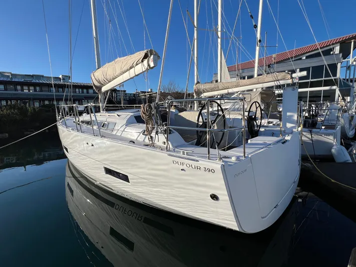  Yacht Photos Pics 2022 Dufour 390 Grand Prix sailboat docked in marina, featuring sleek design and dual steering wheels.