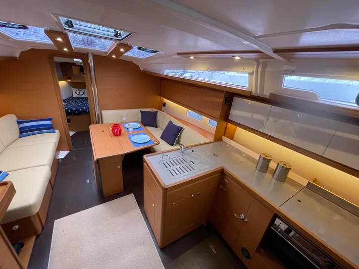  Yacht Photos Pics Interior of 2022 Dufour 390 Grand Prix sailboat, featuring modern kitchen and cozy seating area.