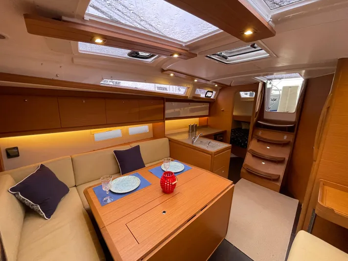  Yacht Photos Pics Interior of 2022 Dufour 390 Grand Prix sailboat, featuring elegant dining area and modern design.